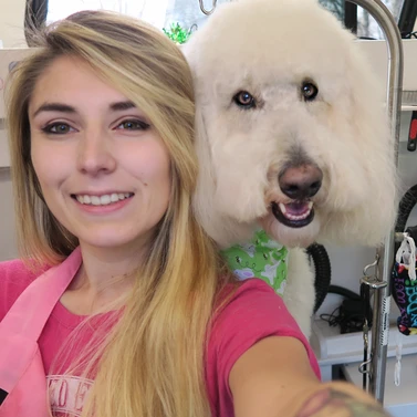 Photo of groomer with dog